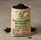 X-HUMATE 25kg potassium humate dry powder in eco-friendly kraft paper bag with English shipping mark, features ultra-fine black humic acid powder on warehouse background.